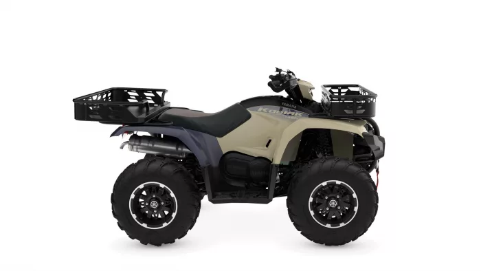 ATV with front and rear cargo baskets, beige and dark gray body, large off-road tires.