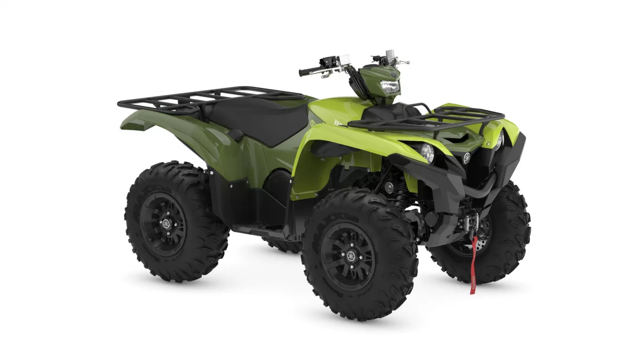 Green Yamaha ATV with oversized off-road tires and front/rear cargo racks, shown from the side in olive and black.