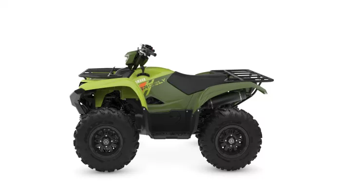 Green Yamaha Grizzly ATV with front and rear cargo racks and chunky off-road tires photographed in profile