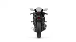 Rear view of a black sport motorcycle with taillight, exhaust, and wide rear tire visible.