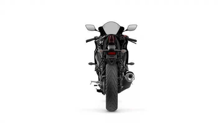 Rear view of a black sport motorcycle with taillight, exhaust, and wide rear tire visible.