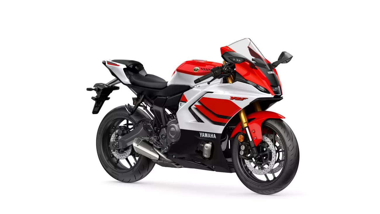 Sporty red-and-white Yamaha motorcycle shown from the front-right side, with a windscreen and disc brakes visible