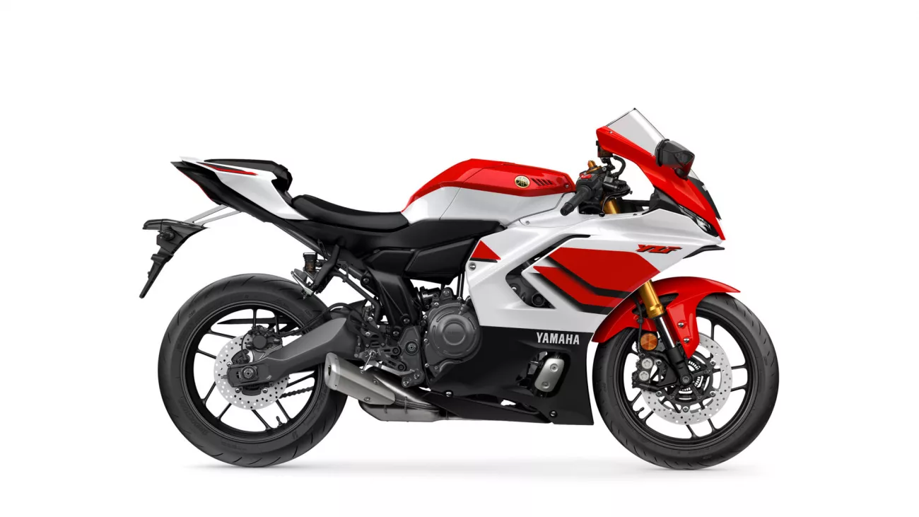 Side view of a red-and-white Yamaha sport motorcycle with black frame and gold front forks.
