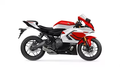 Side view of a red-and-white Yamaha sport motorcycle with black frame and gold front forks.
