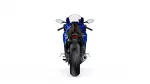 Rear view of a blue sport motorcycle with wide rear tire, taillight, and dual mirrors against a white background, showcasing the bike's stance.