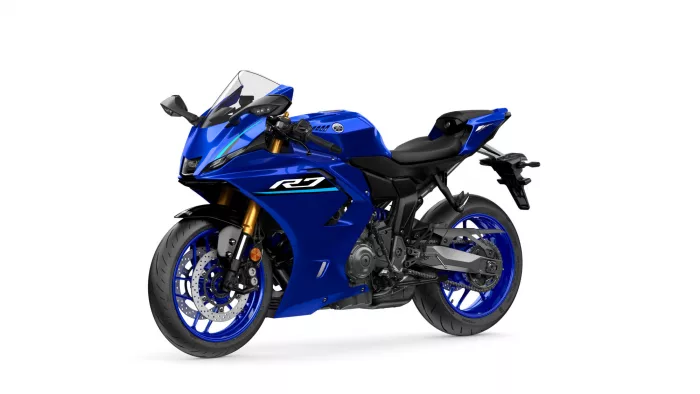 Blue Yamaha sport motorcycle shown from a front-left angle, highlighting its blue fairings and gold front forks.