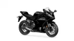Black sport motorcycle photographed from the right side with a clear windshield and angular fairings.