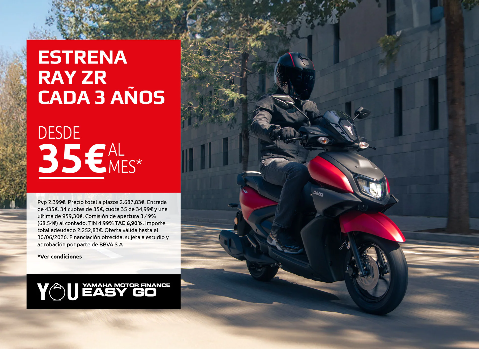 Motorcyclist in black riding gear on a red-and-black scooter beside a large red advertisement panel on a city street.
