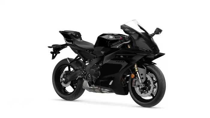 Black sport motorcycle on a white background, angled to show its aerodynamic fairings and front brake discs.
