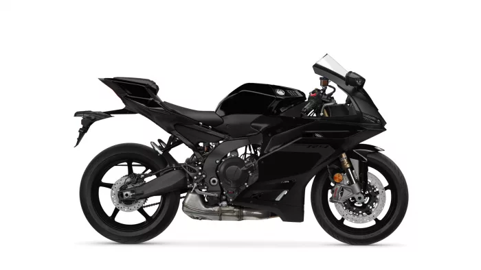 Side view of a black sport motorcycle with sharp fairings against a white background.
