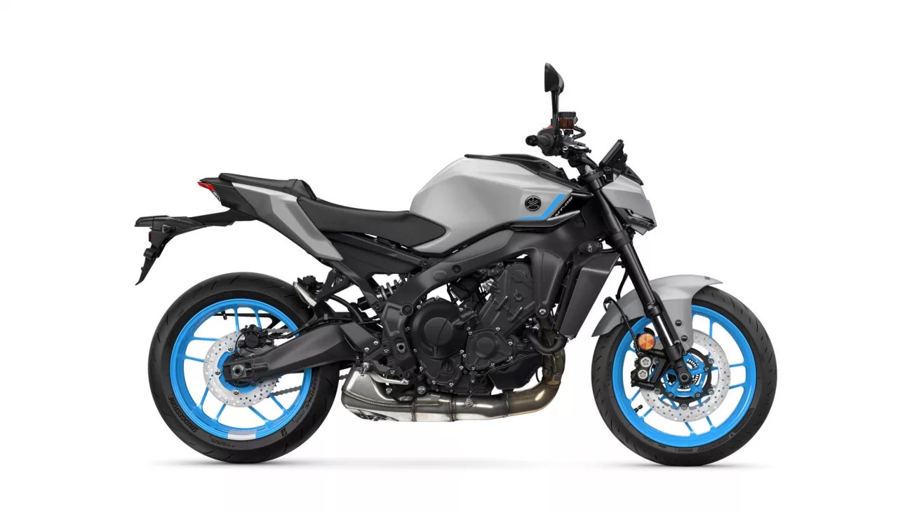 Left-side view of a gray and black sport motorcycle with bright blue rims against a white background, shows the engine and frame details.