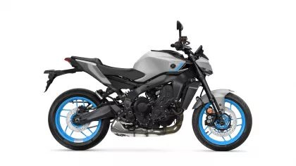Left-side view of a gray and black sport motorcycle with bright blue rims against a white background, shows the engine and frame details.