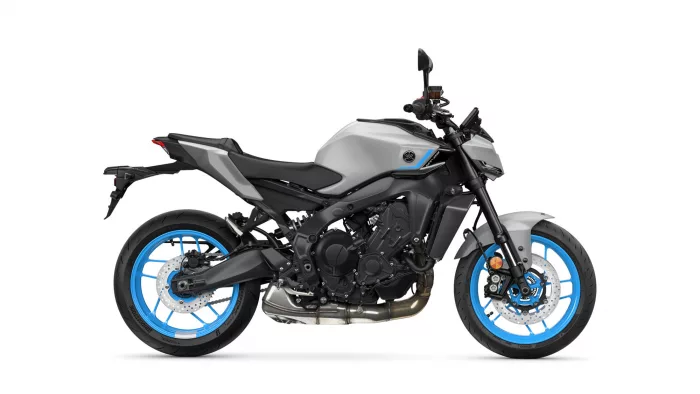 Left-side view of a gray and black sport motorcycle with bright blue rims against a white background, shows the engine and frame details.