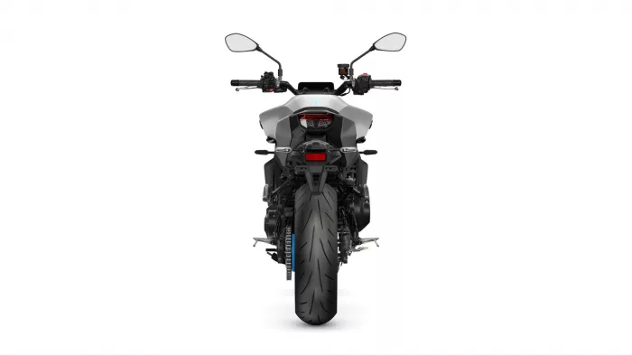 Rear view of a modern gray motorcycle on a white background, showing the wide rear tire, taillight, and side mirrors.