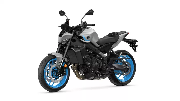 Sport motorcycle shown from a front-left angle, silver body with bright blue rims and black frame parts.