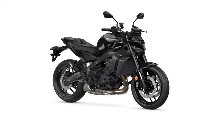 Black sport motorcycle shown in profile with a matte finish, exposed engine, and large front disc brakes on a white background.
