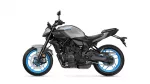 Gray Yamaha MT-07 sport motorcycle with blue alloy wheels and exposed engine, shown in profile