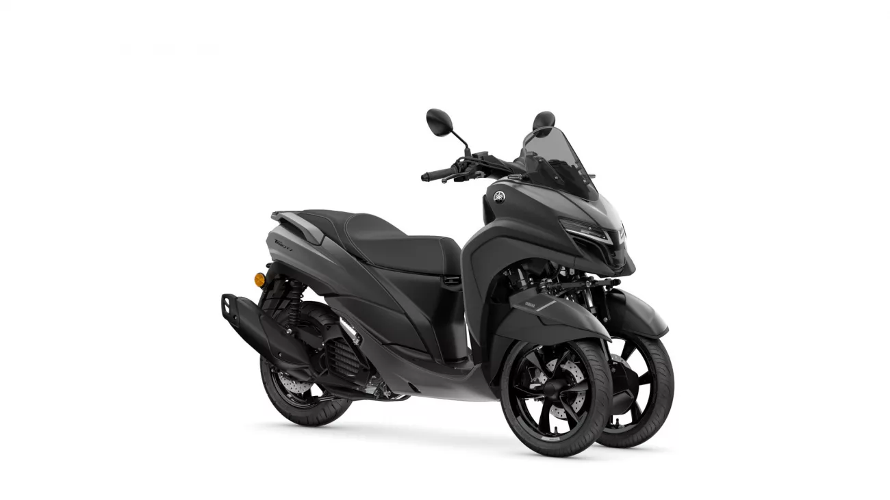 Gray Yamaha Tricity scooter with a tall windshield and dual front wheels, shown from the side.