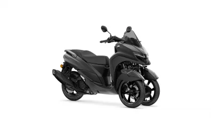 Gray Yamaha Tricity scooter with a tall windshield and dual front wheels, shown from the side.