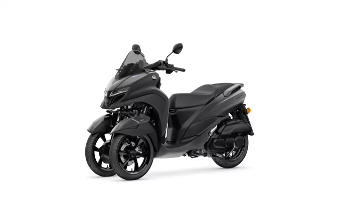 Gray Yamaha three-wheeled scooter with windshield and two-seat configuration, shown from a side-front angle on a white background.