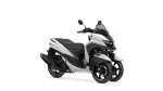 White and black Yamaha Tricity scooter with windshield, side view against a white background