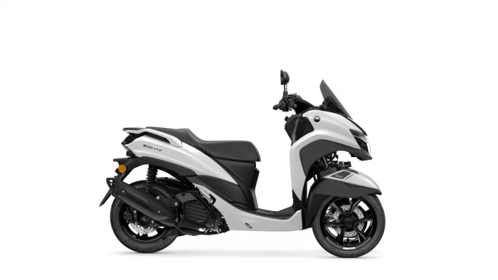 Profile view of a white Yamaha Tricity scooter with black seat and windshield, shown from the left side.