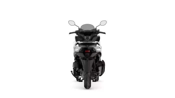 Rear view of a modern motorcycle photographed against a white background, showing the taillight, rear wheel, and seat area clearly.