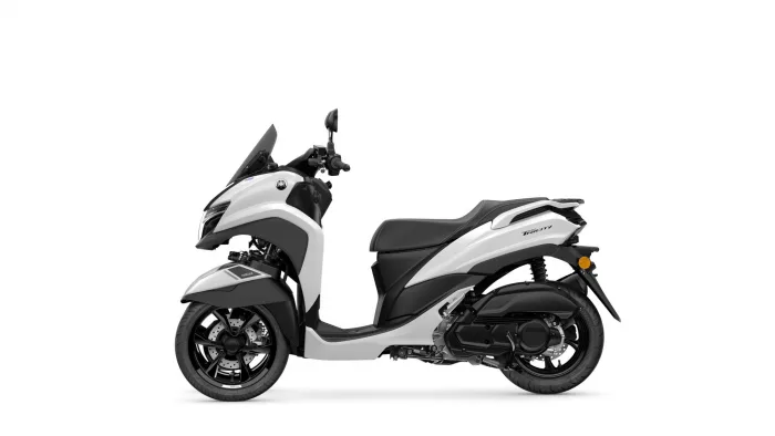 White-and-gray Yamaha Tricity scooter shown in side profile with windshield and dual front fairing panels