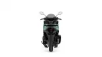 Rear view of a teal and black motorcycle scooter on a white background, showing mirrors and tail area.