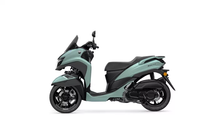 Light teal Yamaha scooter shown in profile, front windshield and seat visible, highlighting its modern design.