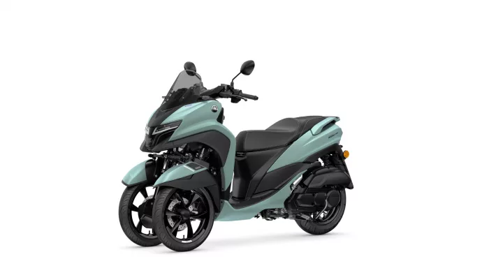 Teal Yamaha Tricity three-wheeled scooter shown from the front-left, with a tall windscreen and black seat.
