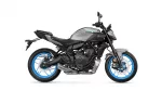 Side view of a gray Yamaha MT-07 motorcycle with bright blue rims against a white background, showing the engine and exhaust detail responsibly visible