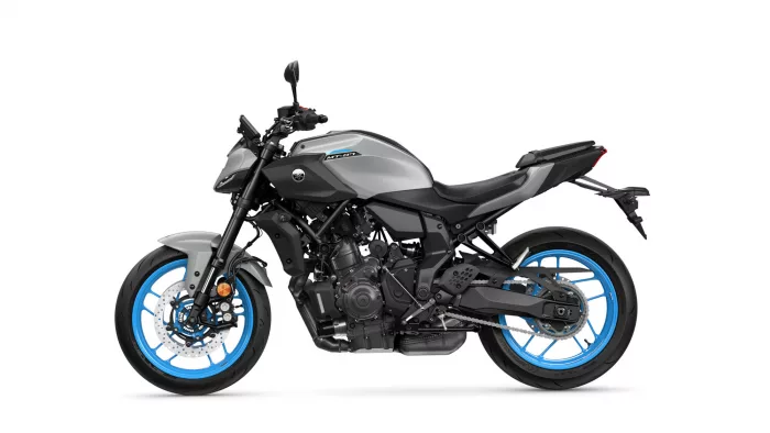 Yamaha MT-07 sport motorcycle in gray and black with bright blue wheels, side view on white background.