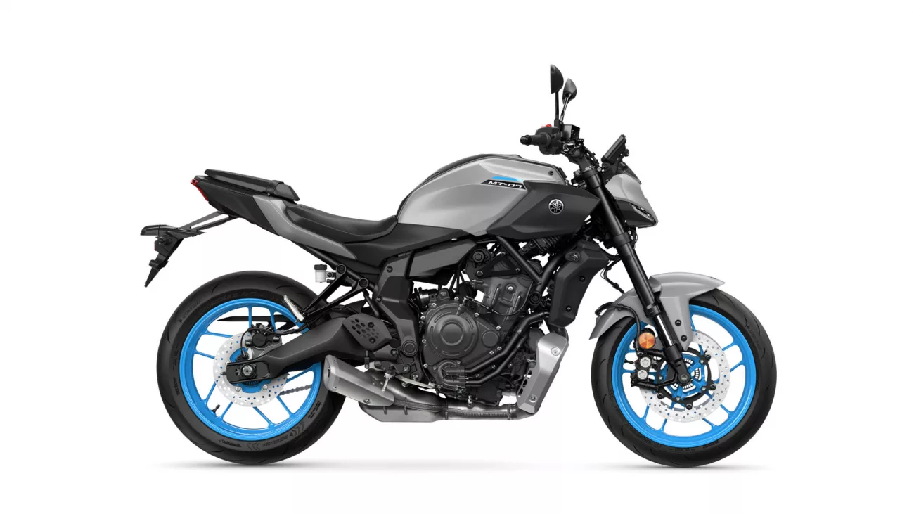 Side view of a gray Yamaha MT-07 sport motorcycle with bright blue rims and exposed engine components, shown against a white background.