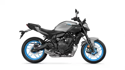 Side view of a gray Yamaha MT-07 sport motorcycle with bright blue rims and exposed engine components, shown against a white background.