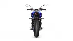 Rear view of a blue sport motorcycle on a white background, showing the taillight and wide rear tire.