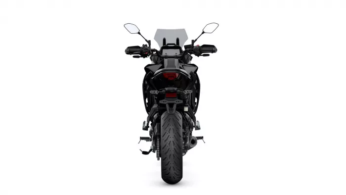 Rear view of a black sport motorcycle showing taillight, rear fender, and wide tire.