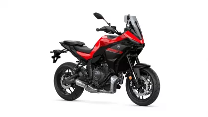 Red and black Yamaha Tracer 7 motorcycle shown in a three-quarter front view against a white background