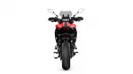 Front view of a red sport/adventure motorcycle, showcasing its windshield, handlebars with mirrors, and chunky front tire