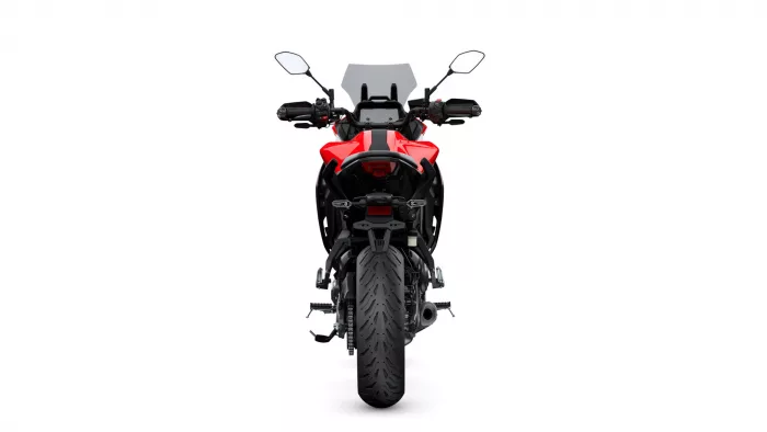 Front view of a red sport/adventure motorcycle, showcasing its windshield, handlebars with mirrors, and chunky front tire