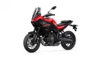 Red and black Yamaha Tracer 7 sport-touring motorcycle, shown from a front-left angle with windshield and exposed engine parts, on a white background.