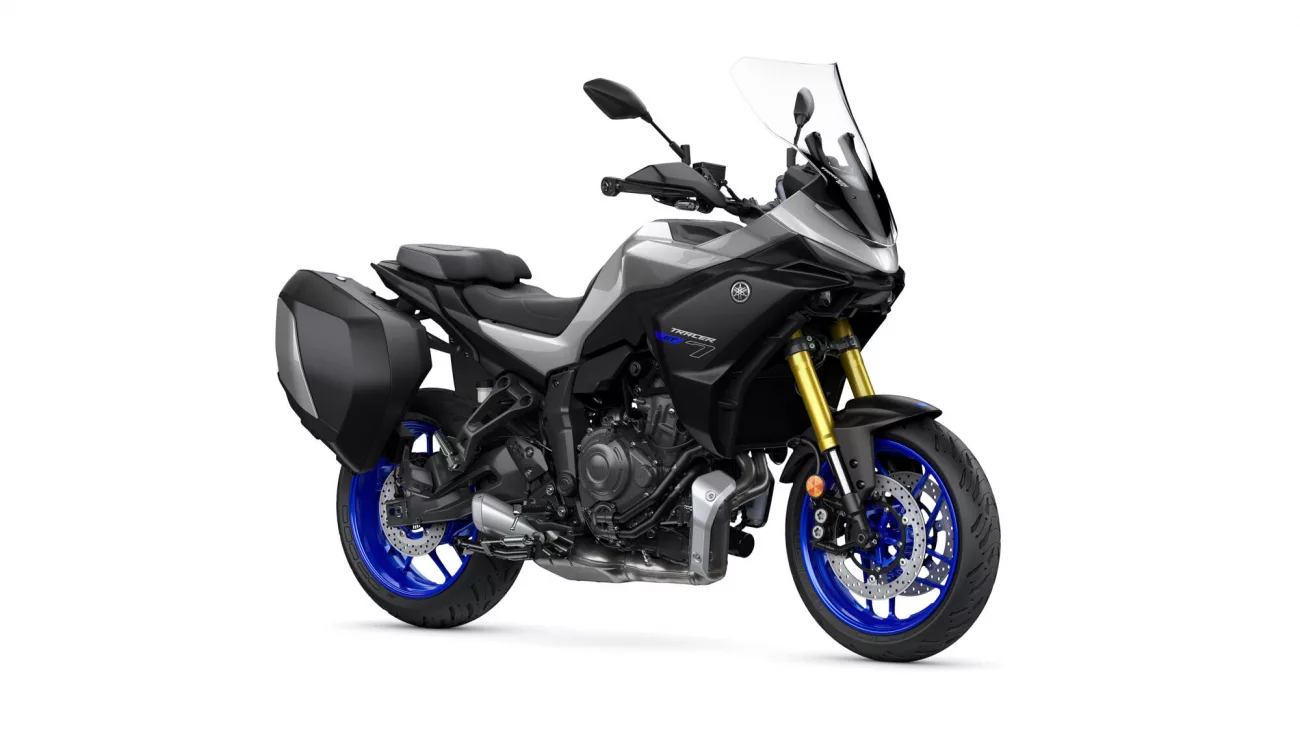 Sport-tourer motorcycle with black bodywork, blue alloy wheels, gold front forks, and hard side panniers with a tall windshield (Yamaha Tracer style).