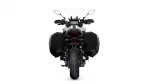 Rear view of a black adventure motorcycle with large side panniers and a tall windshield.