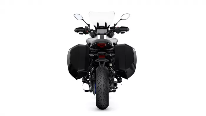Rear view of a black adventure motorcycle with large side panniers and a tall windshield.