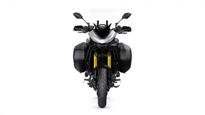 Front view of a black touring motorcycle with a tall windshield and side panniers, facing forward on a white background.