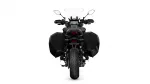 Rear view of a black adventure/touring motorcycle with hard side panniers and a tall windscreen