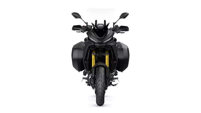 Front view of a black Yamaha adventure motorcycle with side panniers and a tall clear windshield to the rider.