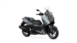 Gray Yamaha XMAX sport scooter with a tall clear windshield, shown in a three-quarter front view on a white background
