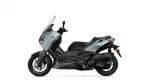 Side view of a Yamaha XMAX scooter in gray and black against a white background, showing front fairing and seat.