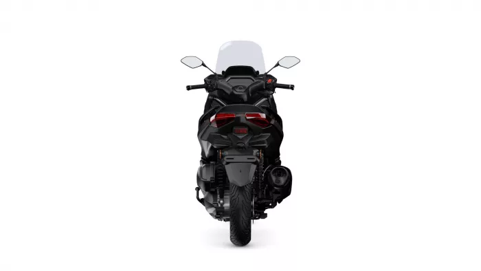Rear view of a black sport motorcycle with red taillights and a tall windshield against a white background.